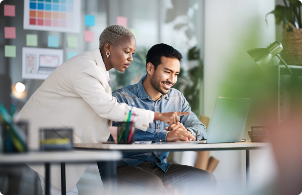 Two professionals analyzing medical data on computer monitors in a modern office setting